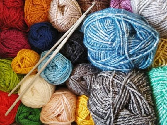 A craft shop that sold yarn, needles, and patterns could suggest knitting.
