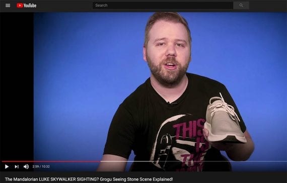 Screenshot of a YouTube video with Eric Voss holding a Vessi shoe