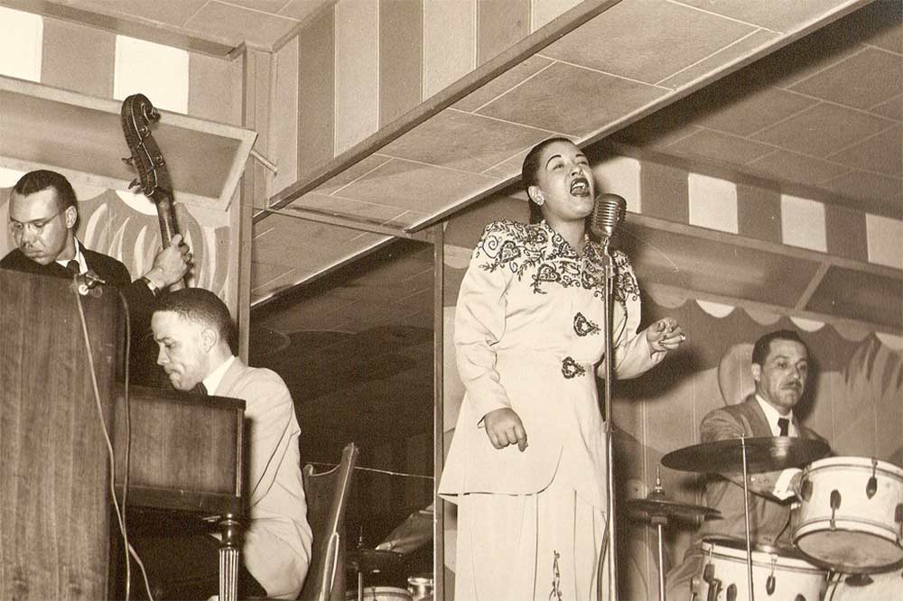 Photo of Billie Holiday singing.