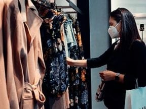 Photo of a female shopping for clothes at a physical store