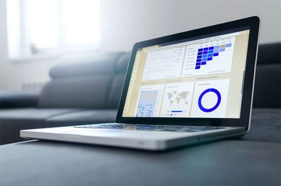 Image of a laptop computer with graphs on the screen