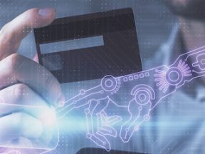 Image of a person holding a credit card