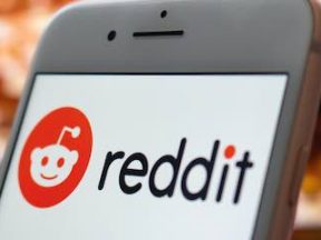 Photo of a smartphone with Reddit logo on the screen