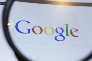 Image of Google logo under a magnifying glass
