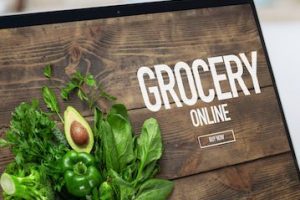 Image of a laptop screen with the words "grocery online"