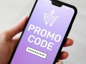 Illustration of a hand holding mobile phone with promo code field displayed on screen