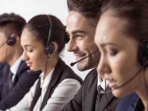Photo of a customer support team speaking on headsets