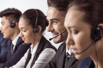Photo of a customer support team speaking on headsets