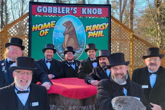 Photo of eight male members of the Punxsutawney Groundhog Club.
