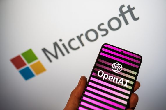 OpenAI logo on phone in a hand and blurred Microsoft logo on the background. Bing integrates ChatGPT AI chatbot to the search engine. Warsaw, Poland - February 15, 2023.
