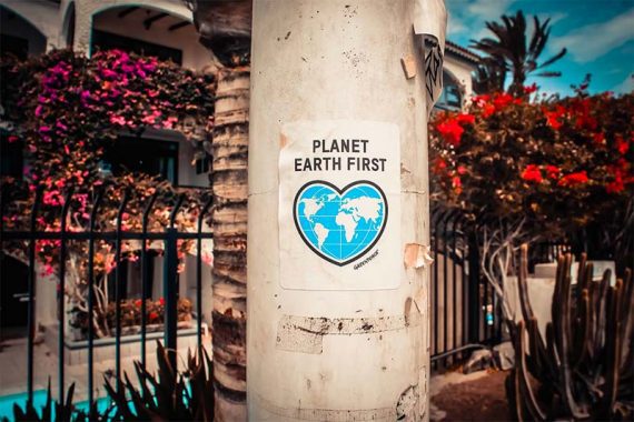 Photo of a paper sign on a post reading "Planet Earth First."