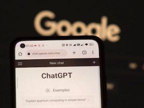 Image of ChatGPT on a smartphone with Google logo in the background