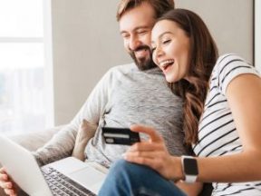 Picture of laughing young couple shopping online