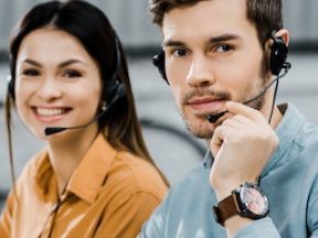 Photo of a male and female wearing headsets for customer support