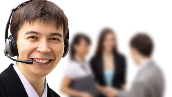 Photo of a male customer service agent wearing a headset.