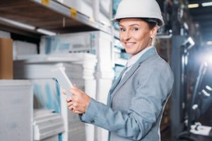 Female holding a clipboard in a factory setting