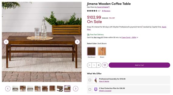 A product page with a photo of a coffee table on a small rug. There's a bottle and glasses on top, and shrubs in the background.
