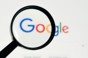 Magnifying glass on top of the Google logo