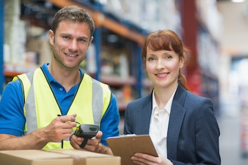 Portrait of manual worker and manager scanning package in the warehouse