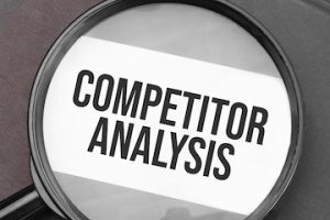 Illustration of the words "Competitor Analysis" behind a magnifying glass