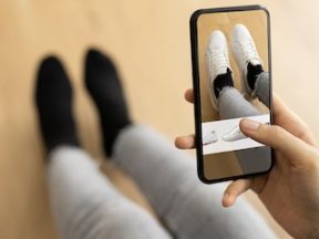 Photo of a shopper virtually trying on shoes on her smarthpone