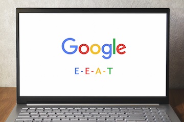 Laptop screen with Google logo and the letters "E - E- A - T"