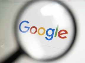 Google search logo on screen through a magnifying glass