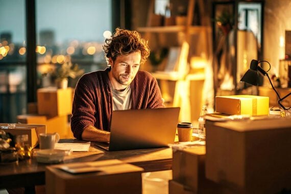 AI image of a male working on a laptop in a living room setting AI image of a male working on a laptop in a living room setting