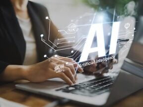 Image of a person typing on a laptop with the illustration "AI" superimposed
