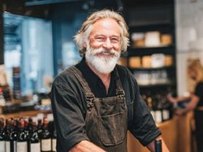 Image of a male wine merchant in his store