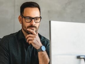 Photo of a male looking at a computer screen