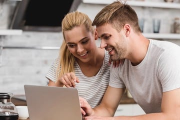 Male and female looking at a laptop computer