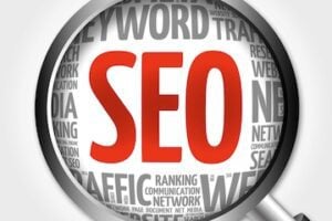 Word cloud for "SEO" behind a magnifying glass