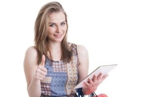 Female with the "thumbs up" sign while holding a computer tablet