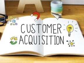 Illustration of the text "Customer Acquisition" on a paper tablet