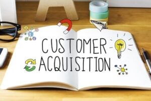 Illustration of the text "Customer Acquisition" on a paper tablet