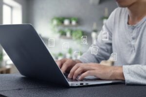 Image of human hands typing on a laptop