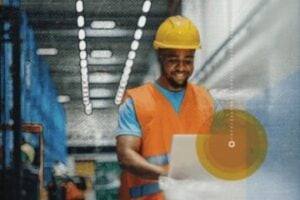 Photo of a male warehouse worker looking at a computer