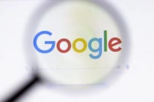 Google logo behind a magnifying glass
