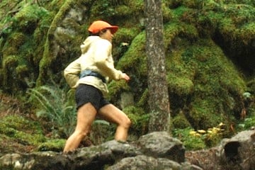 Screenshot from REI's "Uncommon Path" blog showing a female running in a forest