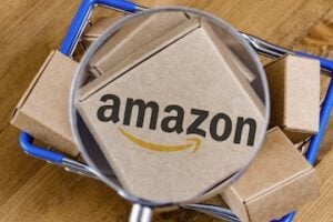 Amazon shipping boxes behind a magnifying glass
