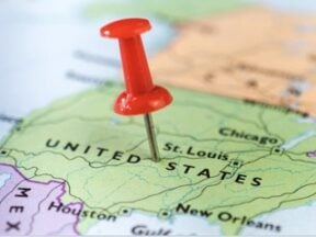 Flat map of the U.S. with a pin in the middle