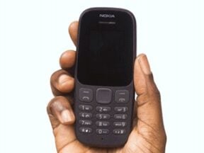 Image from Paystack of a human hand holding a mobile phone