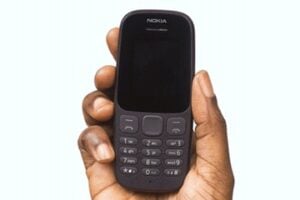 Image from Paystack of a human hand holding a mobile phone