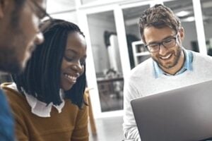 Digital team working around a laptop
