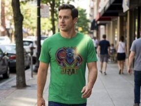 Image from Asset Studio of male wearing a t-shirt while walking on a sidewalk