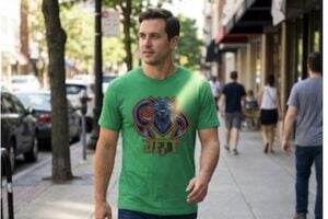 Image from Asset Studio of male wearing a t-shirt while walking on a sidewalk