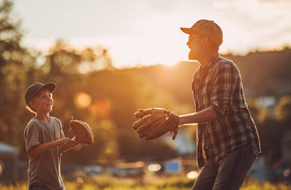 Image of a father and son playing baseball
