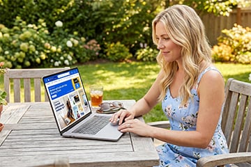 Female shopping outside on a computer