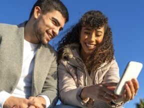 Male and female aged in the 20s looking at a smartphone